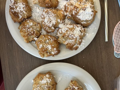 Zwei Teller mit frisch gebackenem Gebäck, bestäubt mit Puderzucker.