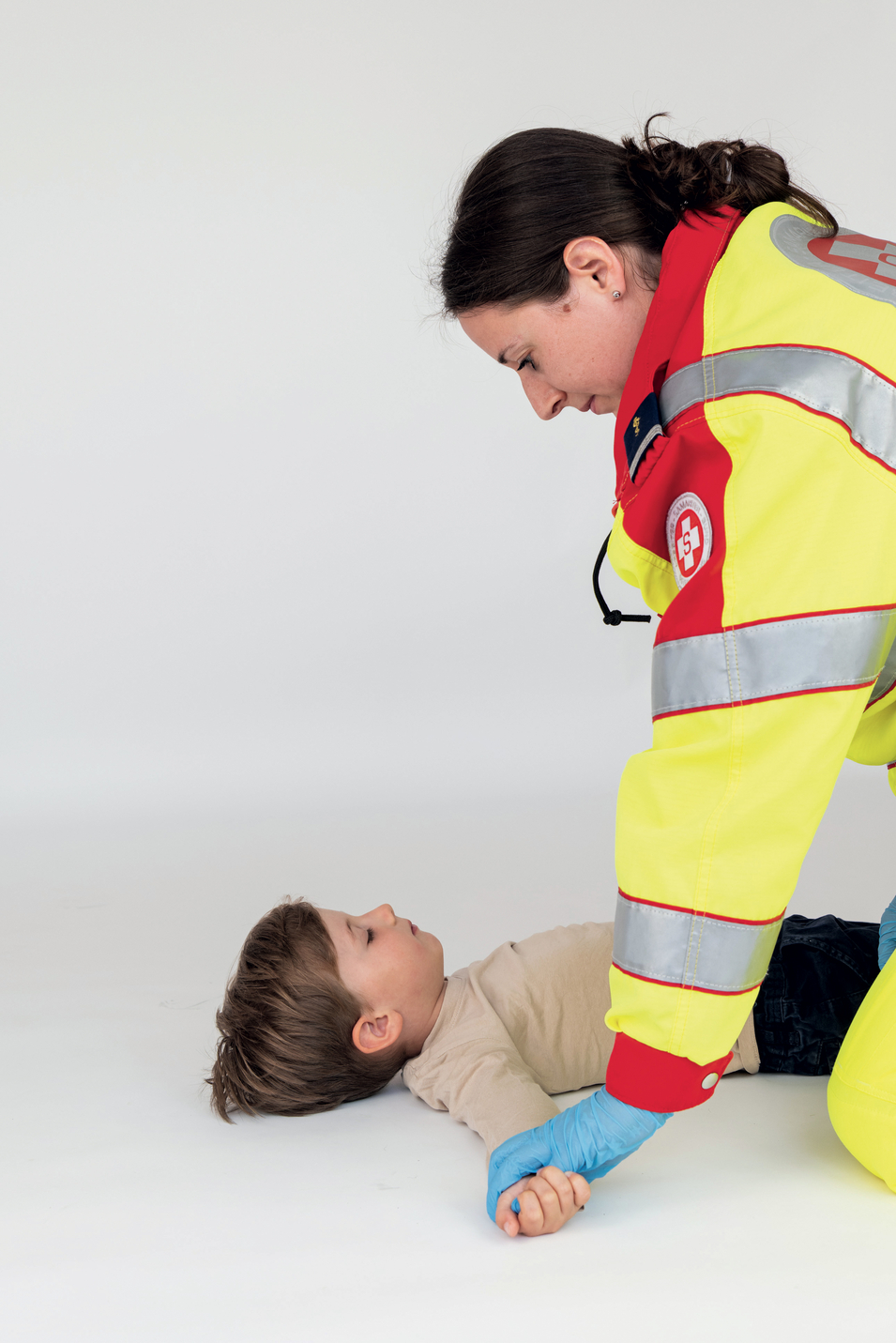 Sanitäterin überprüft Puls bei Kleinkind