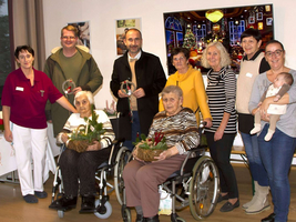 Eine Gruppe von Menschen feiert mit Weihnachtsdekorationen und Handarbeiten.