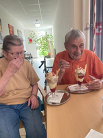 Zwei Personen genießen Eisdesserts in einem hellen, freundlichen Raum.