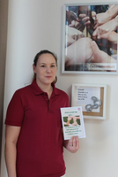 Eine Frau hält ein Plakat mit dem Thema Zusammenhalt in der Hand.